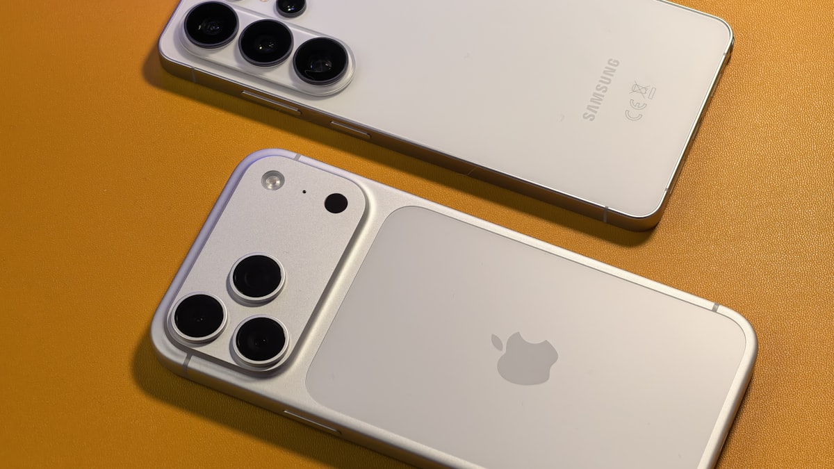 Two smartphones side by side on an orange background, illustrating a head-to-head AT&T plan comparison